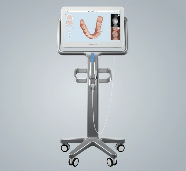 Digital dental scanner on wheeled stand displaying teeth imaging software in clinical setting.