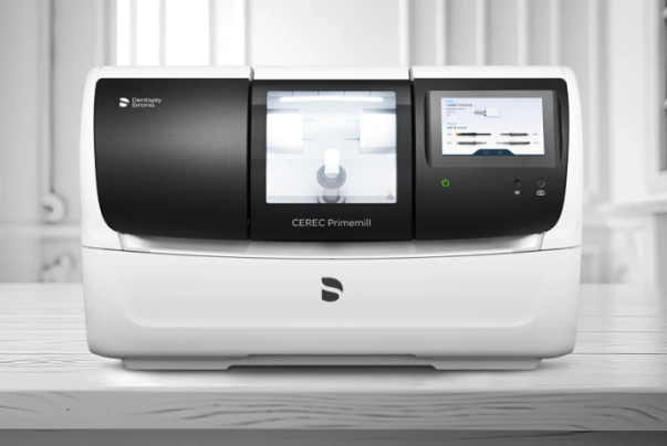 White dental laboratory analyzer machine with black display screens on countertop in clinical setting.
